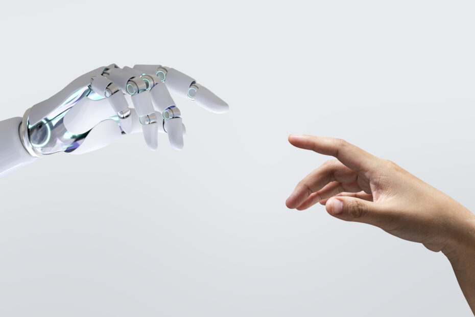 Mano de robot y mano humana a punto de tocarse.